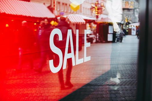 A red sale banner in a window