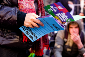 A person holding lots of flyers