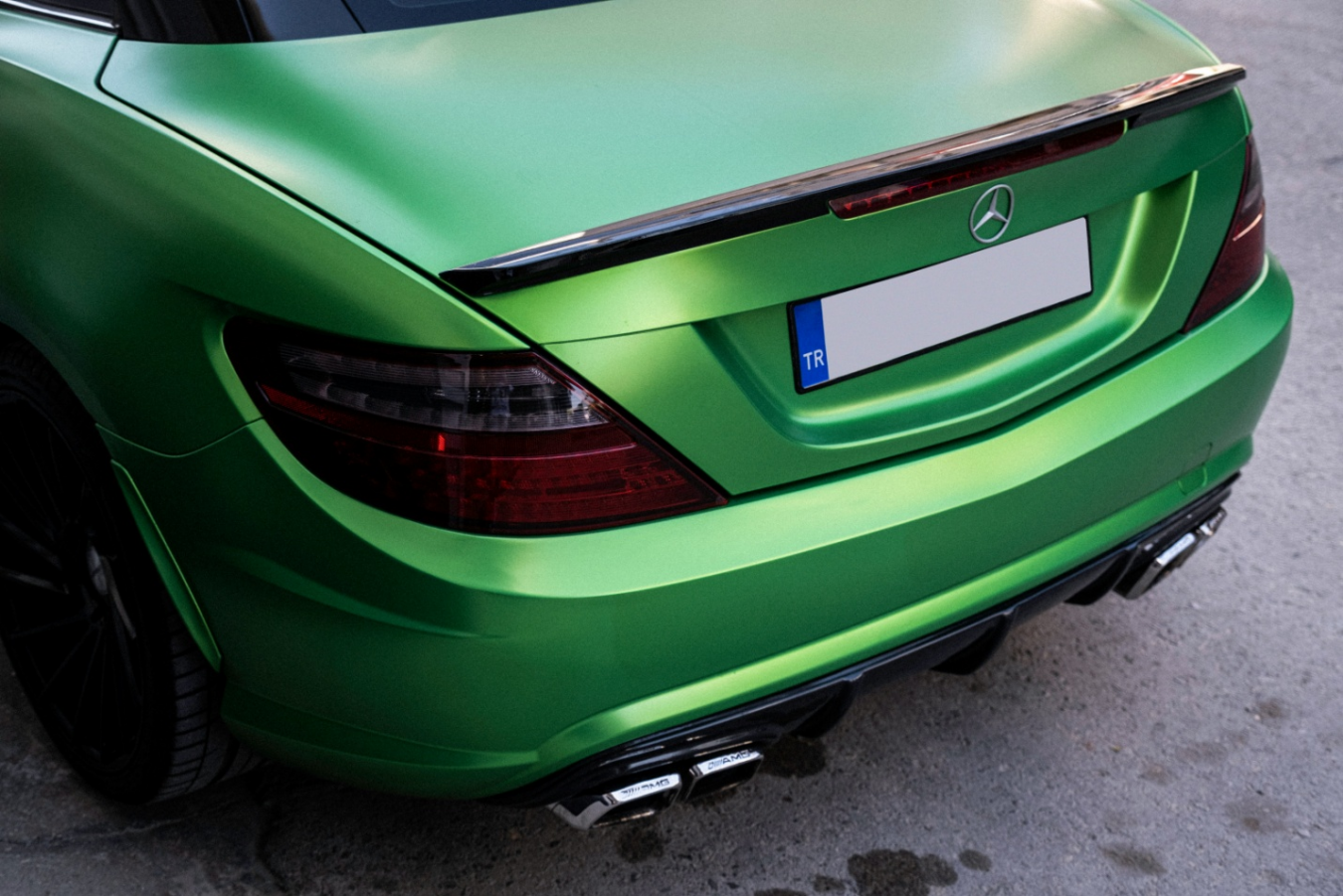 Green Mercedes-Benz car with a glossy green vinyl wrap, showcasing the possibilities of car customization.