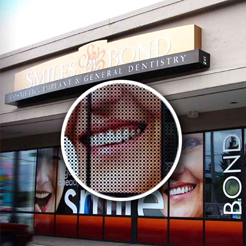 A perforated vinyl banner on a storefront window