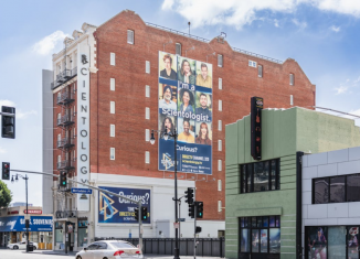 A vibrant, high-resolution,large-format printed banner on a wall promoting a local business