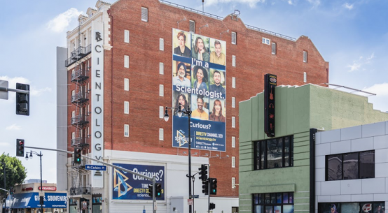 A vibrant, high-resolution,large-format printed banner on a wall promoting a local business