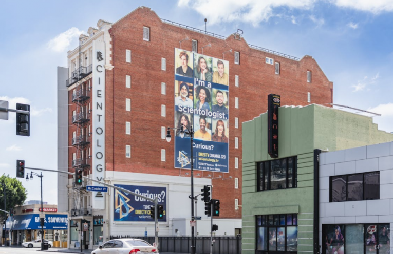 A vibrant, high-resolution,large-format printed banner on a wall promoting a local business