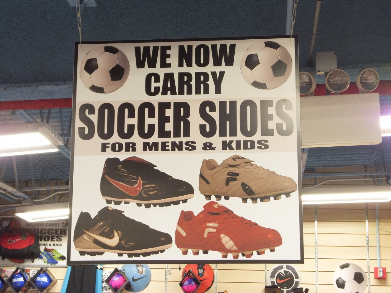 A sign for soccer shoes on a mounted banner