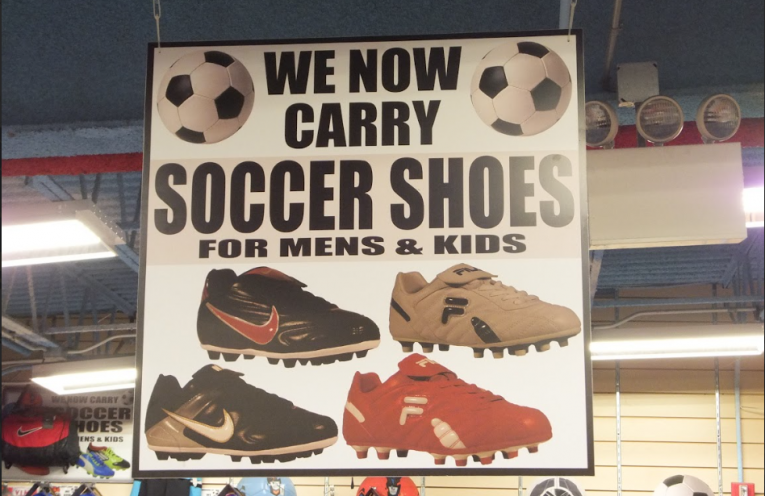 Promotional graphic featuring soccer shoes in a retail-style display