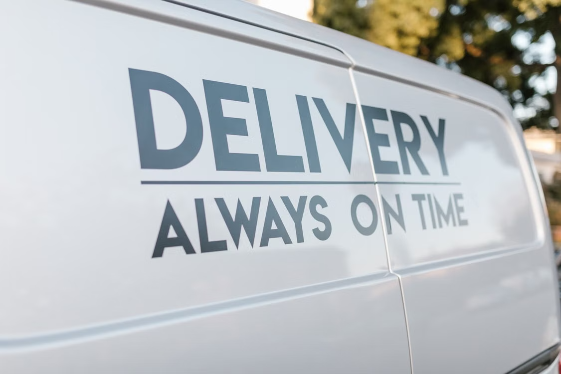 Delivery van featuring printed branding and graphics on its exterior