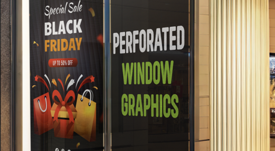 Large printed promotional window graphics applied across a retail storefront