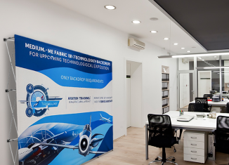 Straight pop-up display wall with large format graphics in a technology office
