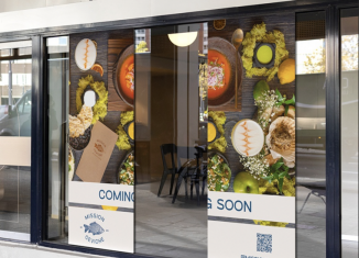 Food-themed adhesive window graphics installed across a restaurant storefront
