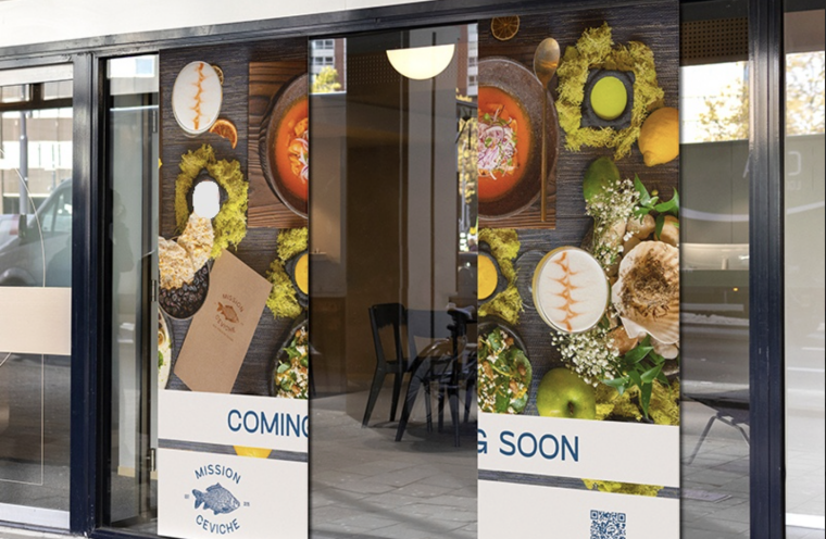Food-themed adhesive window graphics installed across a restaurant storefront