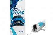 Branded trade show booth with pop-up display, retractable banners, and custom table covering