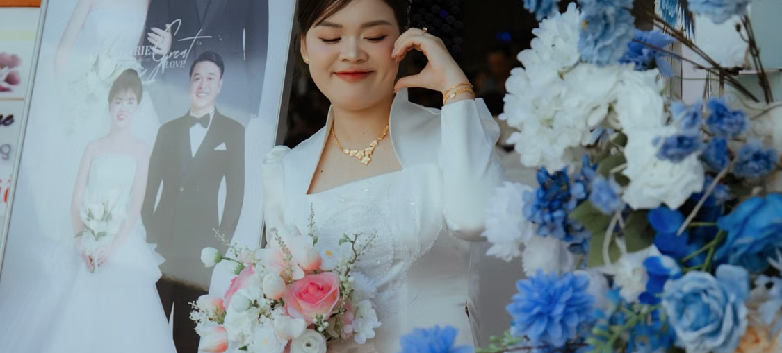 A wedding guest posing with a wedding pop-up display