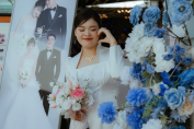 A wedding guest posing with a wedding pop-up display
